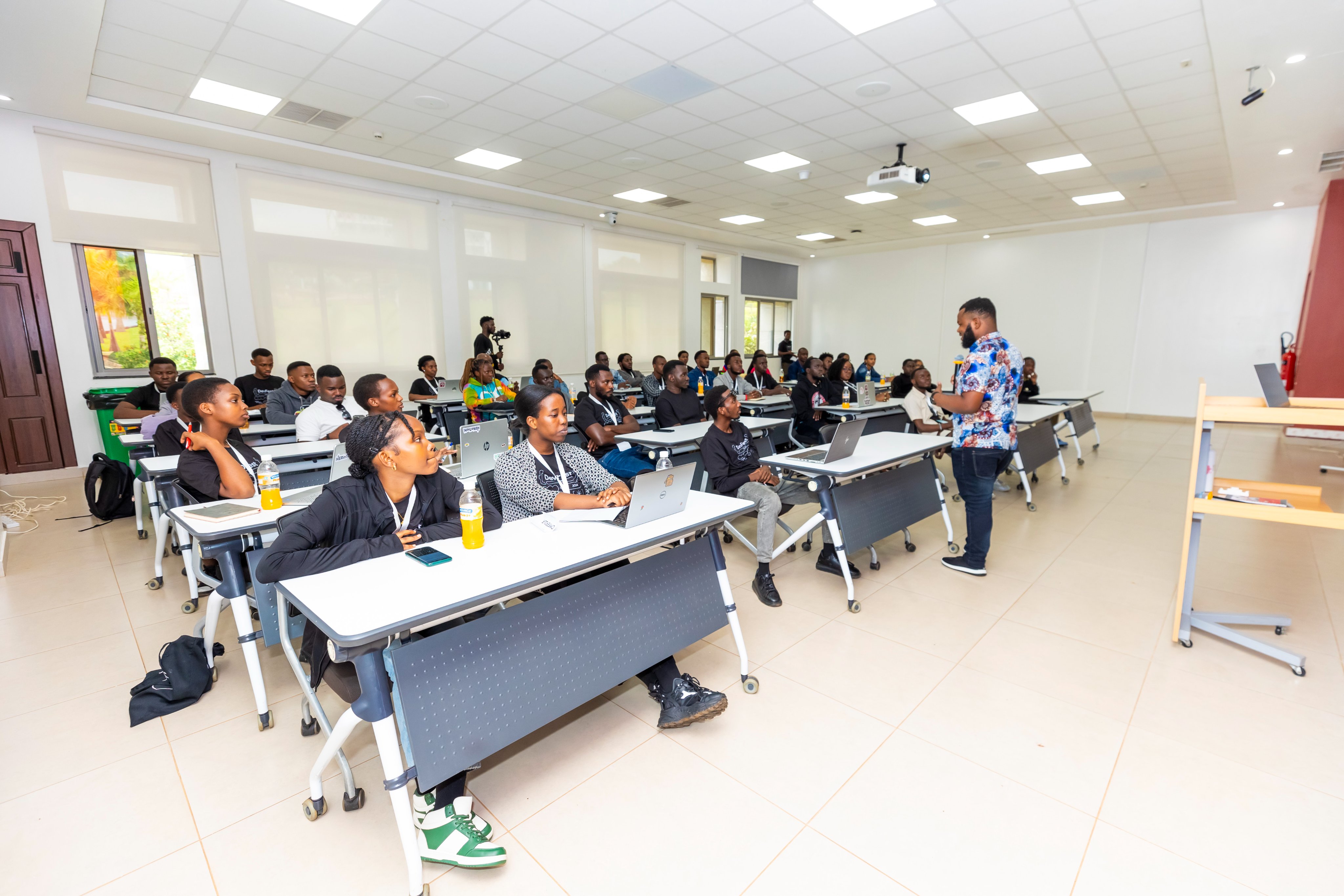 A group of students in a modern classroom setting, learning about AI.